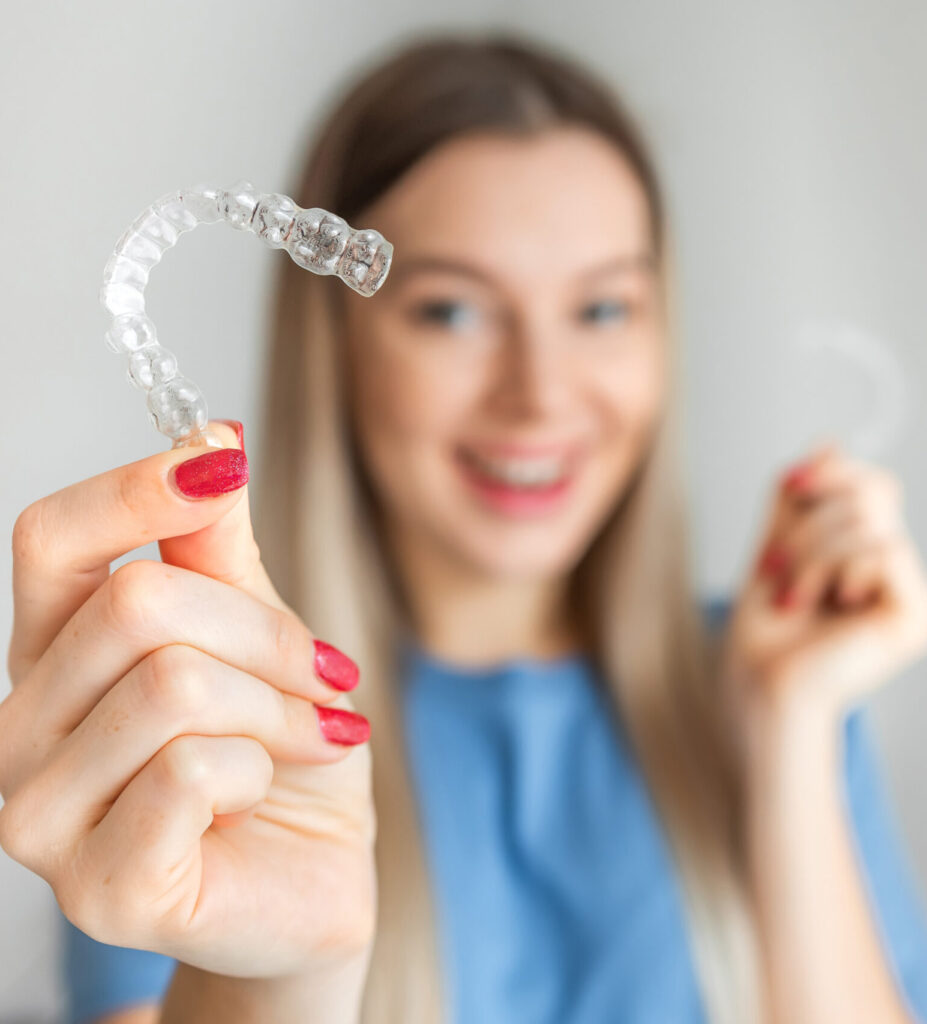 Teenage female holding Invisalign